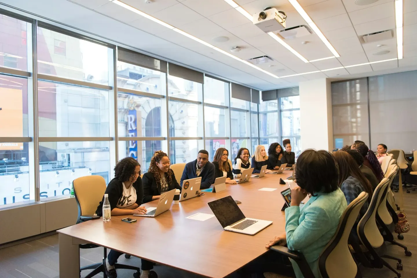 A team around a boardroom table with laptops